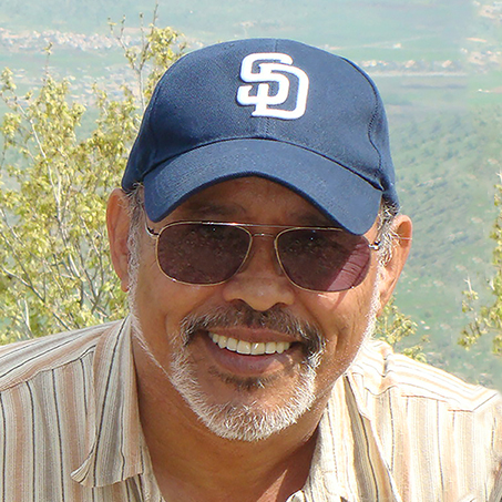 Photo of Fernando Roldan Jr., smiling in a San Diego Padres baseball cap.