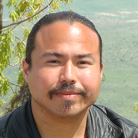 Photo of Jesus Fernando Roldan, outdoors overlooking a valley and smiling.